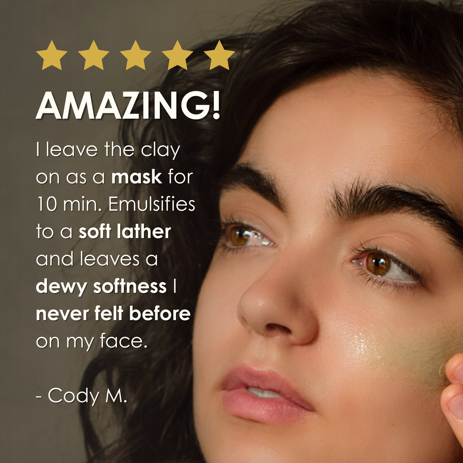 Close-up of model with Cleansing Clay applied to cheek accompanied by a five-star review describing dewy softness and lathering texture.