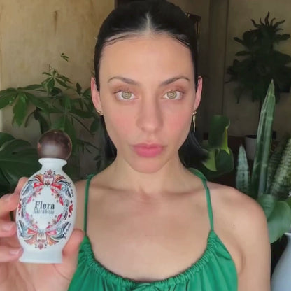 Founder Jordan LaFragola shows how to use the Flora Mirabilis Holy Grail Face Oil, dispensing a few drops into her hands, warming the oil, and massaging it into the face using upward strokes for nourishment and glow.