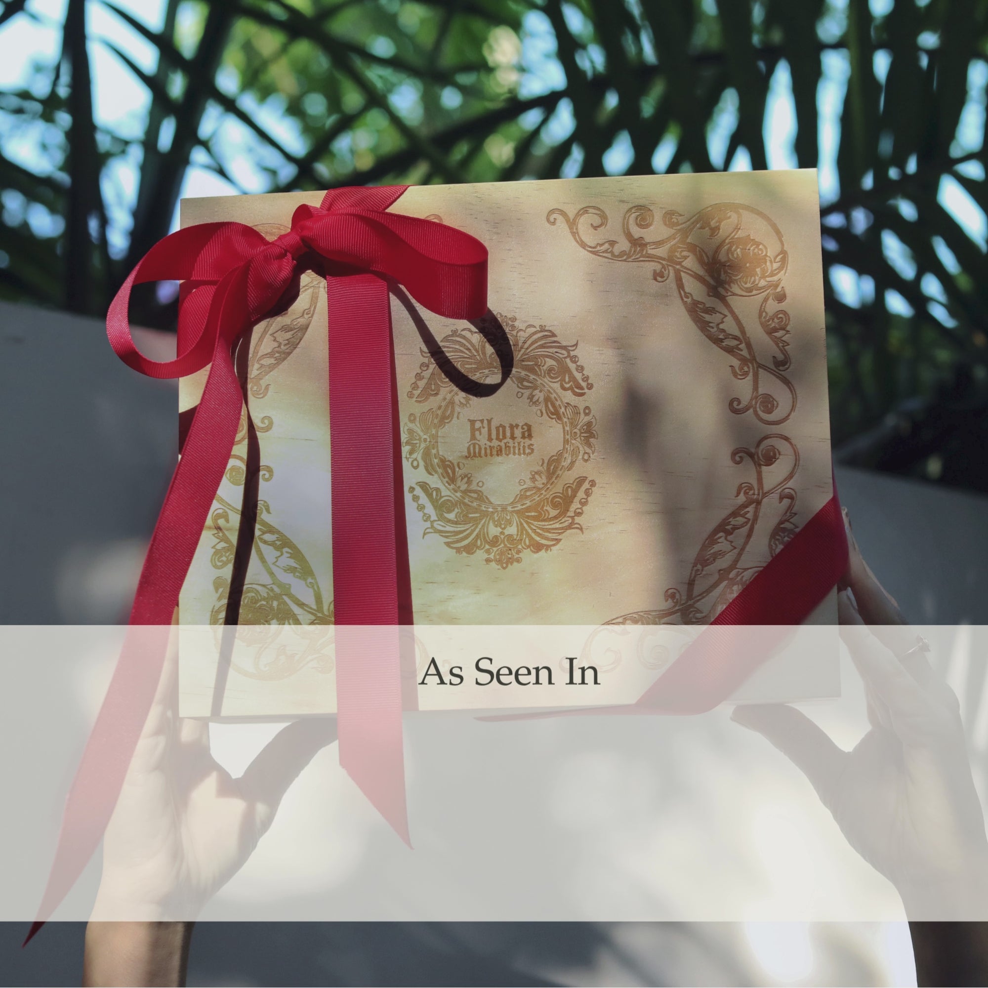 A looping animation showing the Flora Mirabilis Full Regime Gift Set while magazine and press quotes fade in and out behind it including GLAMOUR, Forbes, Town & Country, Santa Barbara Magazine, Bustle, Byrdie, and L'OFFICIEL.