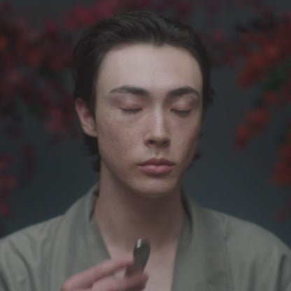 Video with model using Stainless Steel Beauty Tool with Holy Grail Face Oil to perform a Gua Sha-inspired lymphatic facial massage to support lymphatic drainage to sculpt and tone the face.