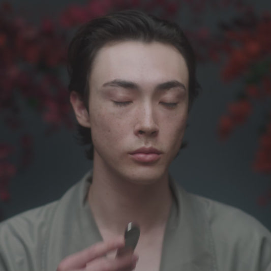 Video with model using Stainless Steel Beauty Tool with Holy Grail Face Oil to perform a Gua Sha-inspired lymphatic facial massage to support lymphatic drainage to sculpt and tone the face.