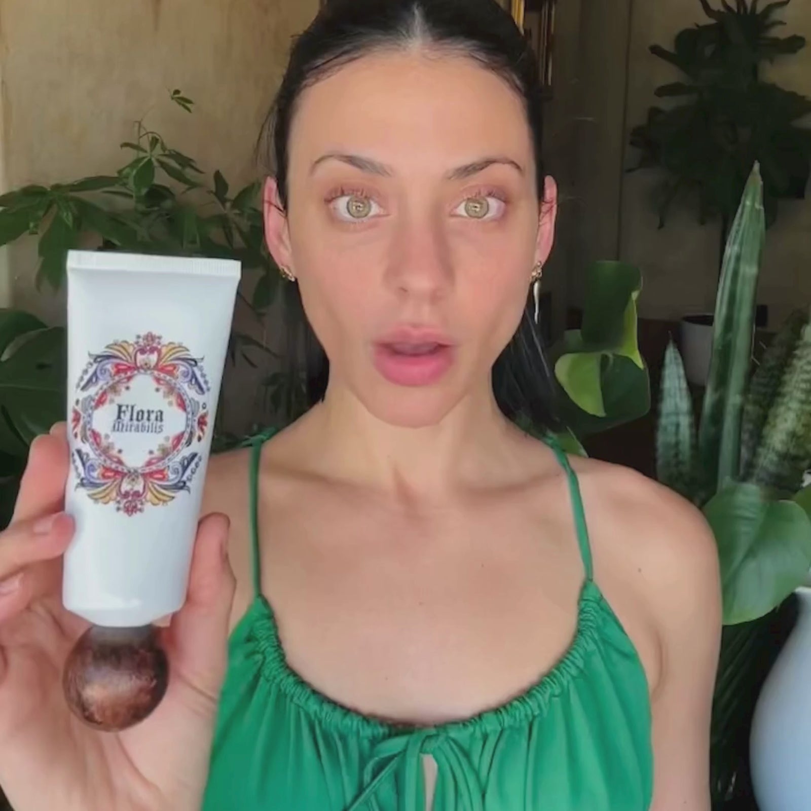 Jordan LaFragola holding the Flora Mirabilis Fountain of Youth Cleansing Clay tube while explaining how to use the product.